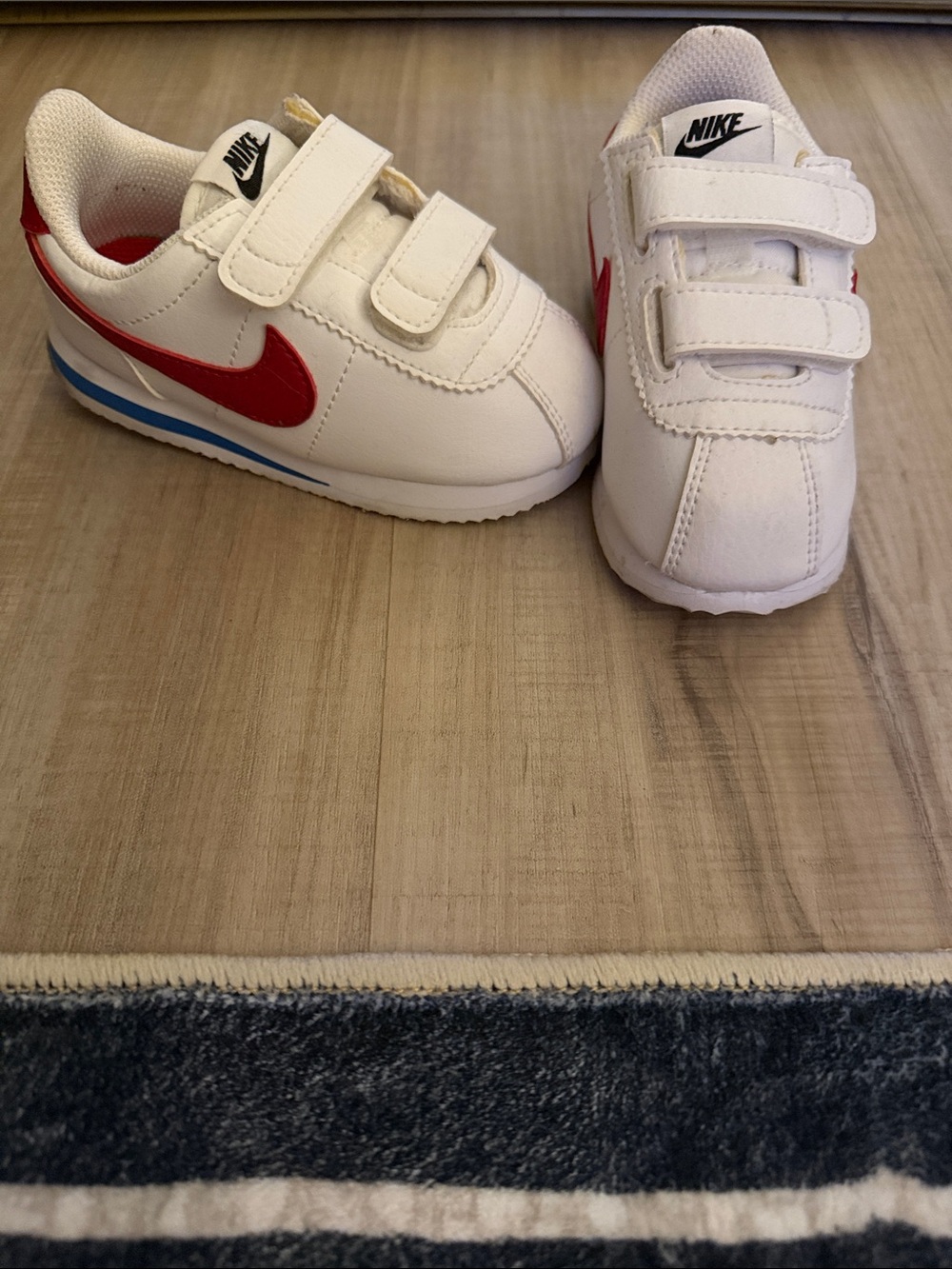 Nike Kids White Sneakers with Red Swoosh and Blue Stripe